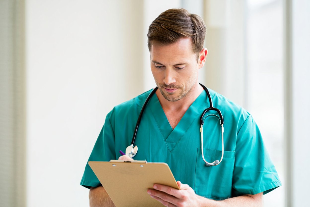 Врач смотрит в планшетку